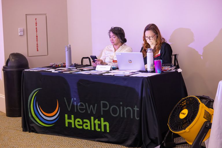 View Point Health vendor table with two people sitting at the table